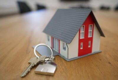 miniature white and red wooden house on a brown table