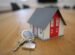 miniature white and red wooden house on a brown table