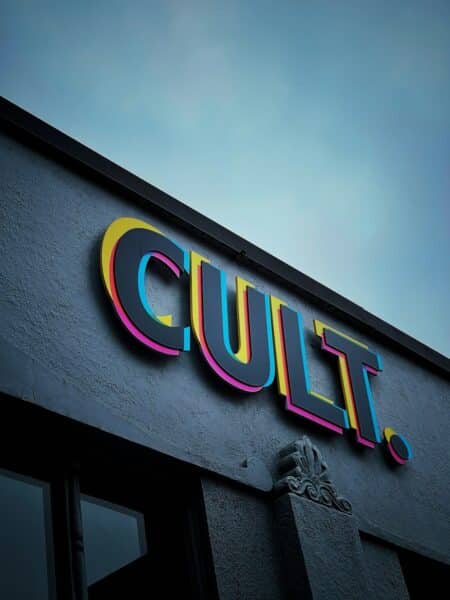 a neon sign on the side of a building a neon sign on the side of a building