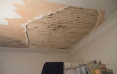 A room with a ceiling that has been torn off