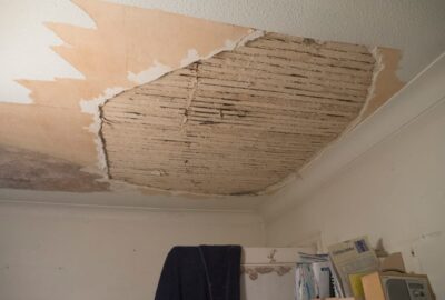 A room with a ceiling that has been torn off