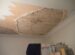 A room with a ceiling that has been torn off
