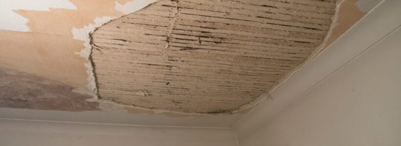 A room with a ceiling that has been torn off